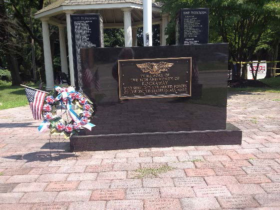 Veterans Memorial brick walkway, memorial towers, american flag