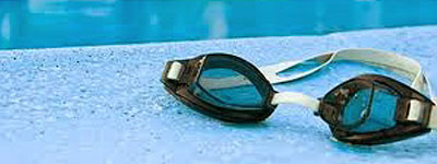 swim goggles by edge of pool
